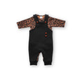 Black baby overalls worn over a long-sleeve leopard print bodysuit, Infant or toddler outfit set featuring black overalls with wooden buttons and a brown leopard print top