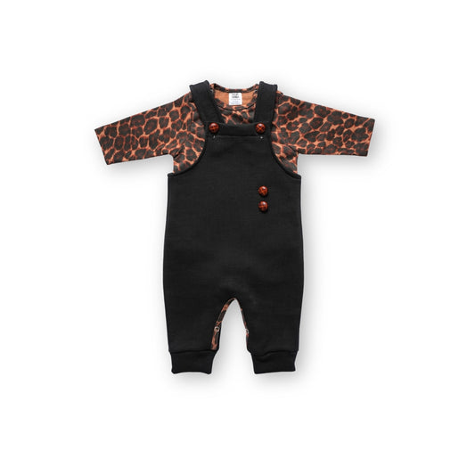 Black baby overalls worn over a long-sleeve leopard print bodysuit, Infant or toddler outfit set featuring black overalls with wooden buttons and a brown leopard print top