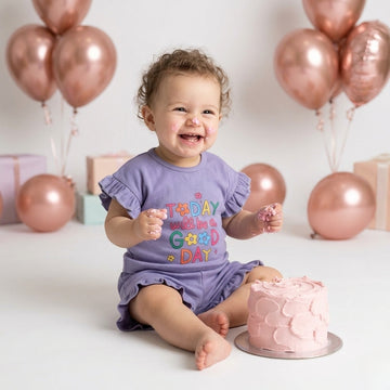 A baby girl is weared a palm and pale purple color today will be a good day print with frill shirt and frill short to repesent the premium quality of coton fabric for summer weather for newborn baby to 5 years baby girl.