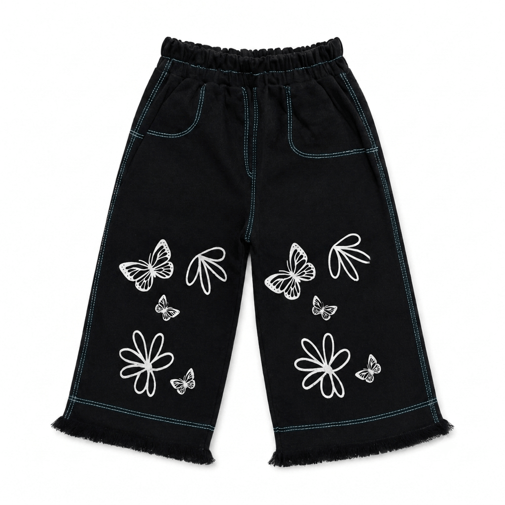 Girls' black wide leg denim pants with white butterfly and floral outline print, teal contrast stitching, elastic waist, and frayed hem — front view