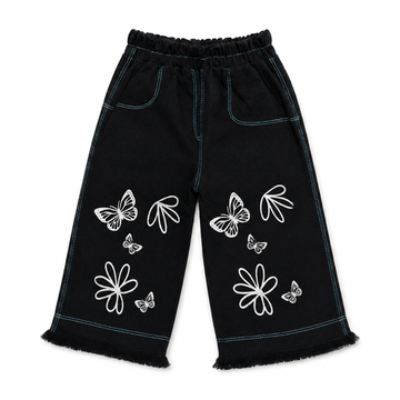 Girls' black wide leg denim pants with white butterfly and floral outline print, teal contrast stitching, elastic waist, and frayed hem — front view