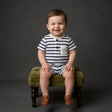 A baby boy model is weared a palm and pale stripe white and blue romper to repesent the premium quality of coton fabric for summer weather for newborn baby to 24 months baby boy.