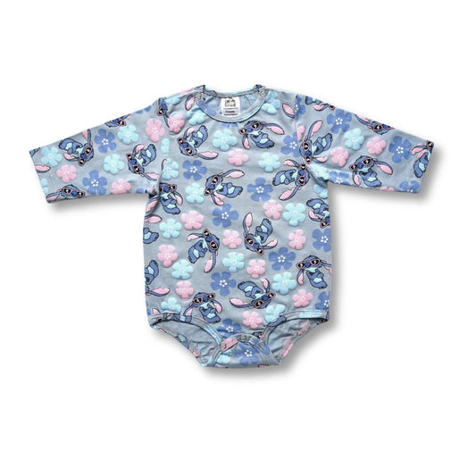 Baby onesie with cartoon character pattern on a white background