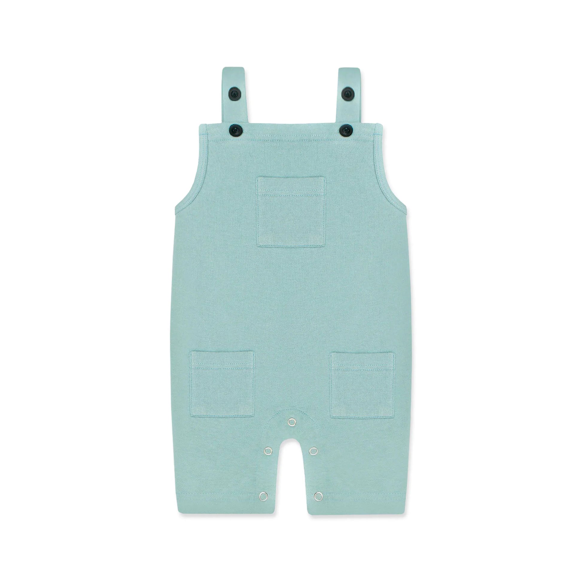A pastel blue newborn romper with button-on-shoulder straps and front pockets, displayed against a light background with orange and green design elements. The text highlights features like 'Button on Shoulder,' 'Pockets,' and 'New Arrivals.' The brand name 'Palm and Pale' and website 'palmandpale.com' are also visible. The tagline reads 'Sunny styles for little smiles.'
