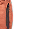 Close-up of a brown fabric with a dark gray interior on a white background