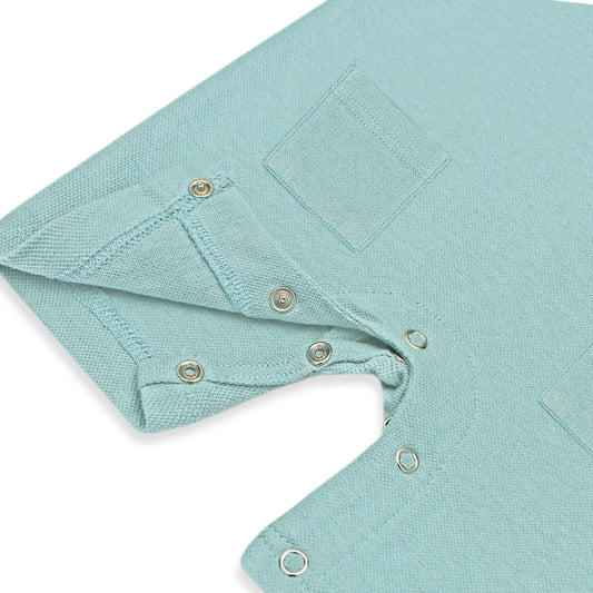 Newborn baby romper 0 months to 24 months and pocket on the front side and snap button on legs for opening 
A pastel blue newborn romper with button-on-shoulder straps and front pockets, displayed against a light background with orange and green design elements. The text highlights features like 'Button on Shoulder,' 'Pockets,' and 'New Arrivals.' The brand name 'Palm and Pale' and website 'palmandpale.com' are also visible. The tagline reads 'Sunny styles for little smiles.'